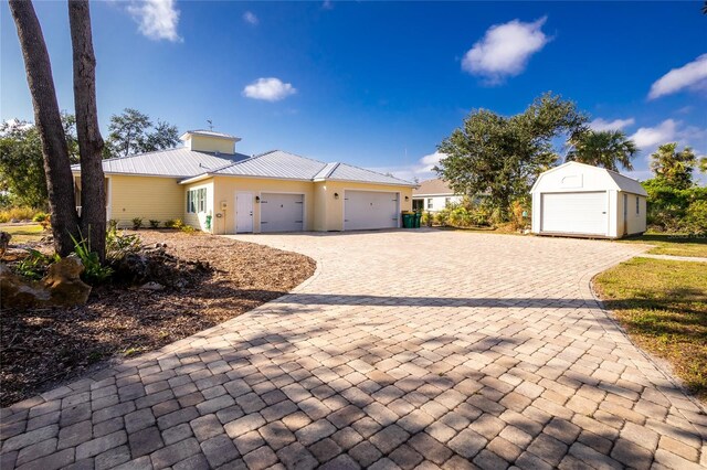 13204 Kakapo Ave, Port Charlotte, FL 33981 - ranch-style house with a garage, decorative driveway, metal roof, and an outbuilding