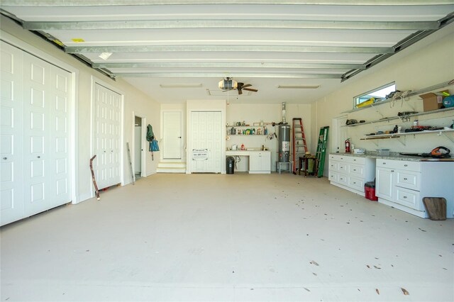 13204 Kakapo Ave, Port Charlotte, FL 33981 - garage with a workshop area, gas water heater, and a garage door opener