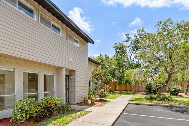 4346 Rayfield Dr Unit 4346, Sarasota, FL 34243 - view of side of home with uncovered parking and a patio