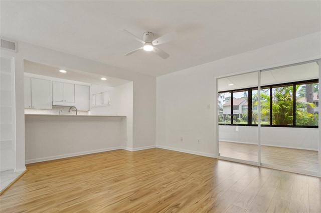 4346 Rayfield Dr Unit 4346, Sarasota, FL 34243 - unfurnished living room featuring ceiling fan, light wood-style flooring, baseboards, a sink, and recessed lighting