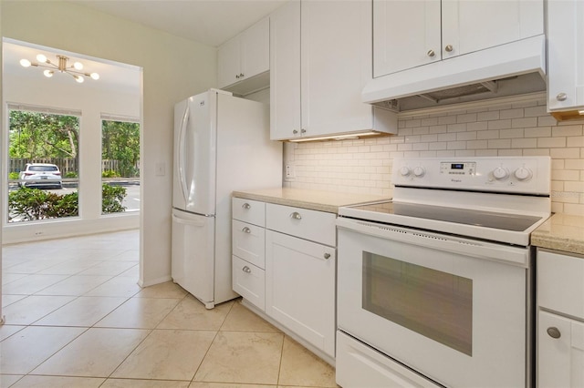 4346 Rayfield Dr Unit 4346, Sarasota, FL 34243 - kitchen featuring white appliances, custom exhaust hood, light countertops, backsplash, and white cabinets