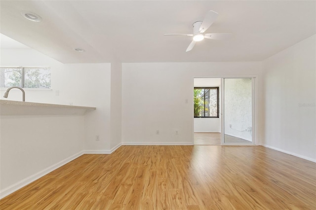 4346 Rayfield Dr Unit 4346, Sarasota, FL 34243 - empty room with light wood finished floors, baseboards, a ceiling fan, and a sink