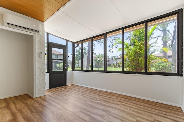 4346 Rayfield Dr Unit 4346, Sarasota, FL 34243 - unfurnished sunroom with a wall unit AC, healthy amount of natural light, and wood finished floors