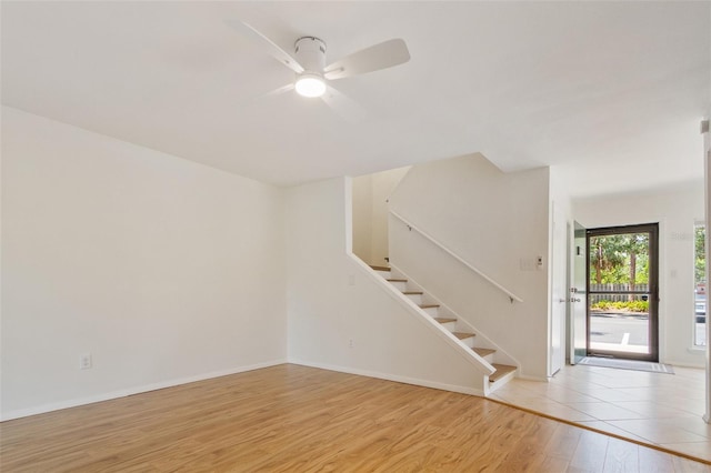 4346 Rayfield Dr Unit 4346, Sarasota, FL 34243 - unfurnished living room featuring stairway, light wood finished floors, ceiling fan, and baseboards