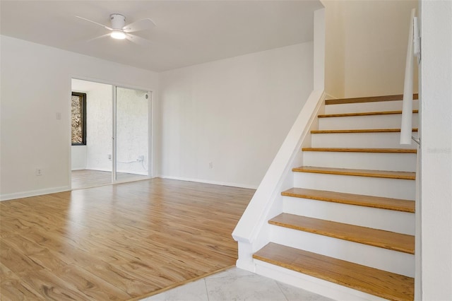 4346 Rayfield Dr Unit 4346, Sarasota, FL 34243 - stairs featuring ceiling fan, wood finished floors, and baseboards