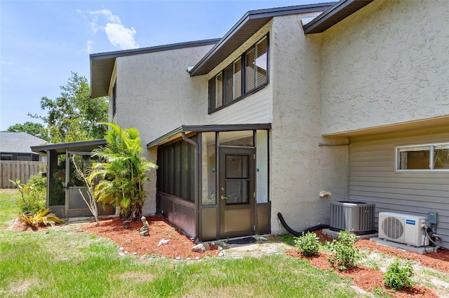 4346 Rayfield Dr Unit 4346, Sarasota, FL 34243 - back of property featuring a sunroom, stucco siding, and central AC unit
