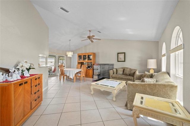891 Bayard St, Port Charlotte, FL 33948 - living room with vaulted ceiling, light tile patterned floors, and a ceiling fan