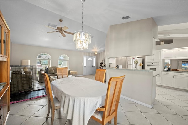891 Bayard St, Port Charlotte, FL 33948 - dining space with light tile patterned floors, a chandelier, a ceiling fan, and high vaulted ceiling
