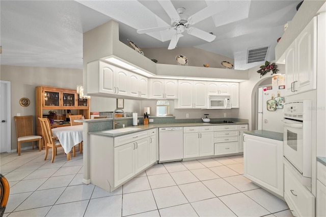 891 Bayard St, Port Charlotte, FL 33948 - kitchen featuring white appliances, a sink, a peninsula, ceiling fan, and vaulted ceiling