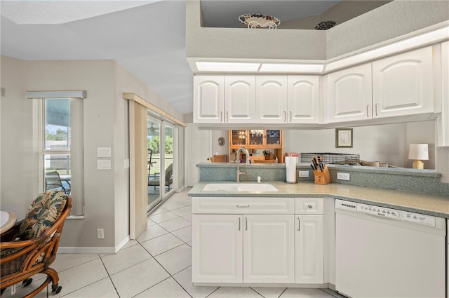 891 Bayard St, Port Charlotte, FL 33948 - kitchen with dishwasher, a sink, light tile patterned flooring, white cabinets, and baseboards