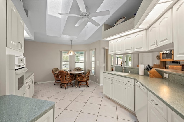 891 Bayard St, Port Charlotte, FL 33948 - kitchen with white appliances, a sink, baseboards, light tile patterned floors, and lofted ceiling