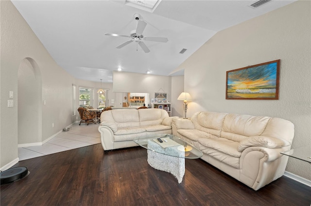 891 Bayard St, Port Charlotte, FL 33948 - living room featuring lofted ceiling, arched walkways, wood finished floors, a ceiling fan, and baseboards