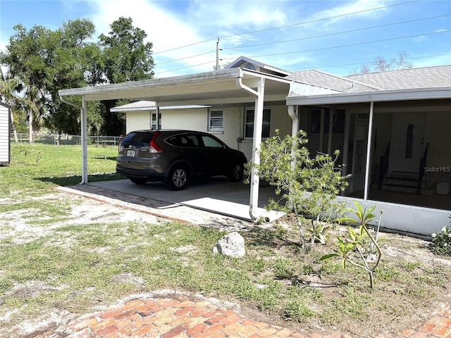 404 W Whidden St, Arcadia, FL 34266 - view of side of property featuring a sunroom, roof with shingles, and an attached carport