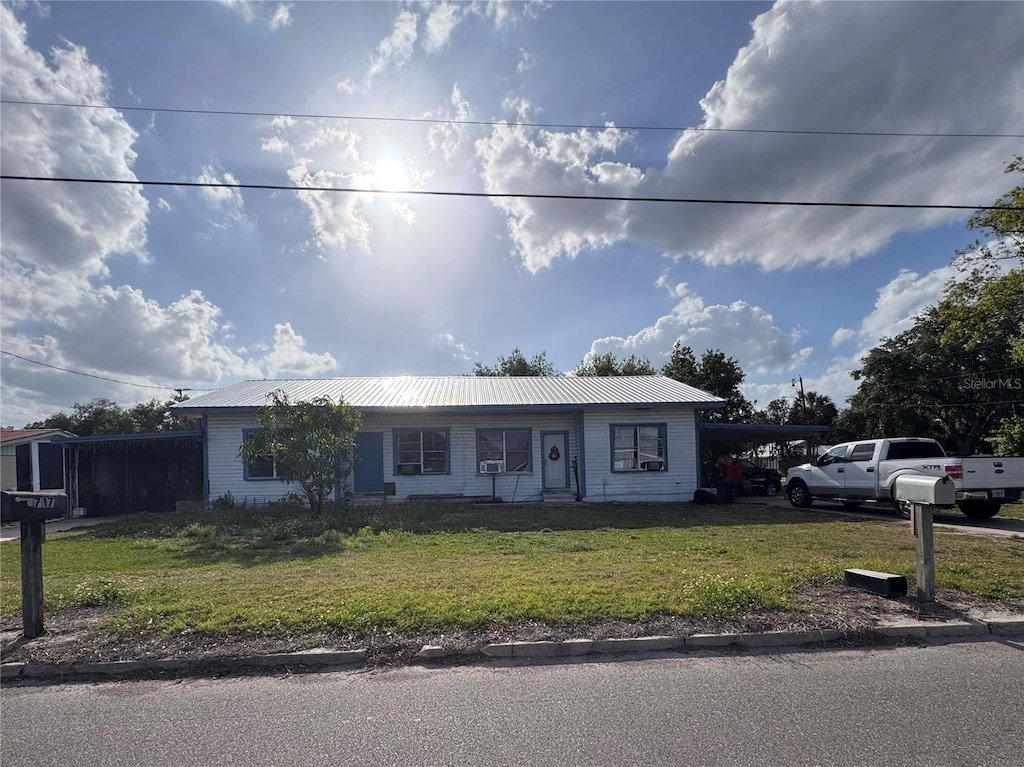 601 N Waldron St, Arcadia, FL 34266 - single story home featuring a front yard, an attached carport, and a metal roof