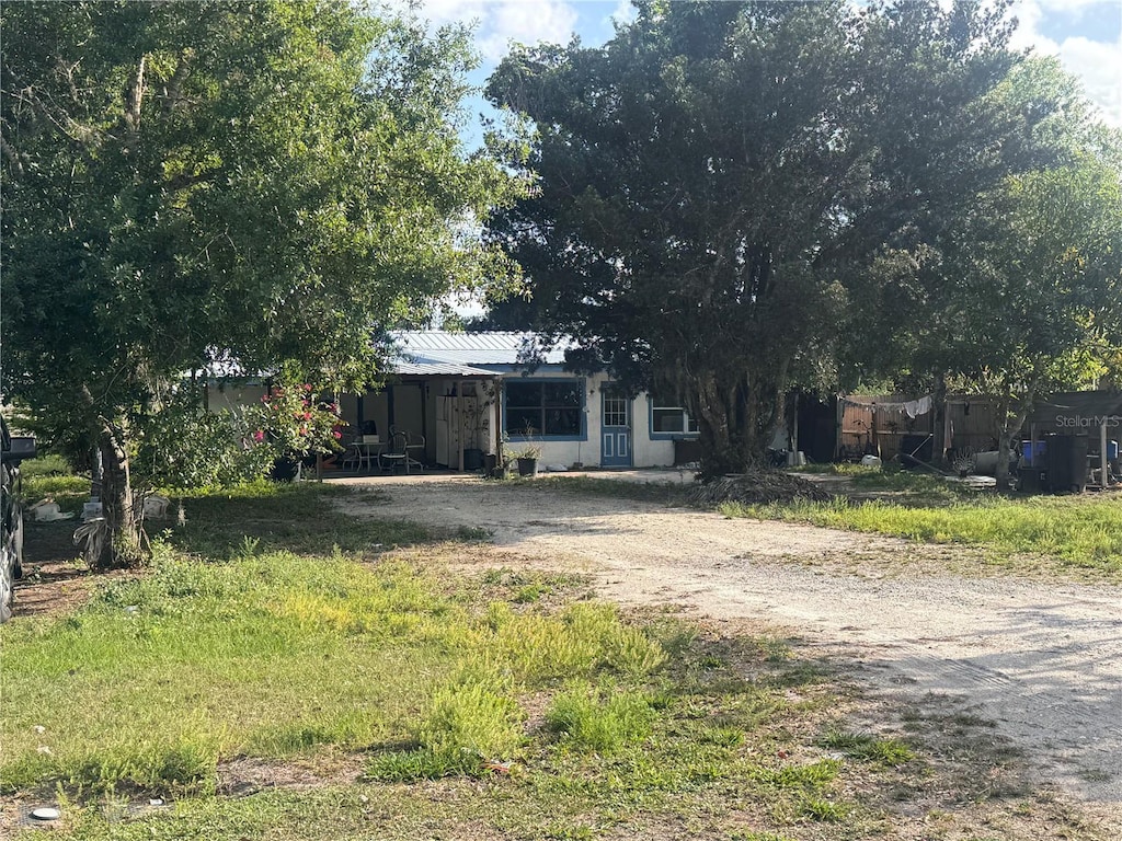601 N Waldron St, Arcadia, FL 34266 - view of front of home with a metal roof and driveway