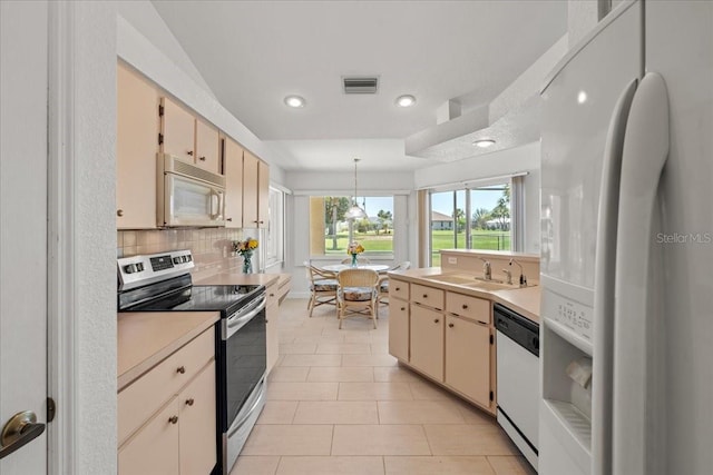 7334 N Tulip Tree, Punta Gorda, FL 33955 - kitchen with white appliances, a sink, light countertops, recessed lighting, and backsplash