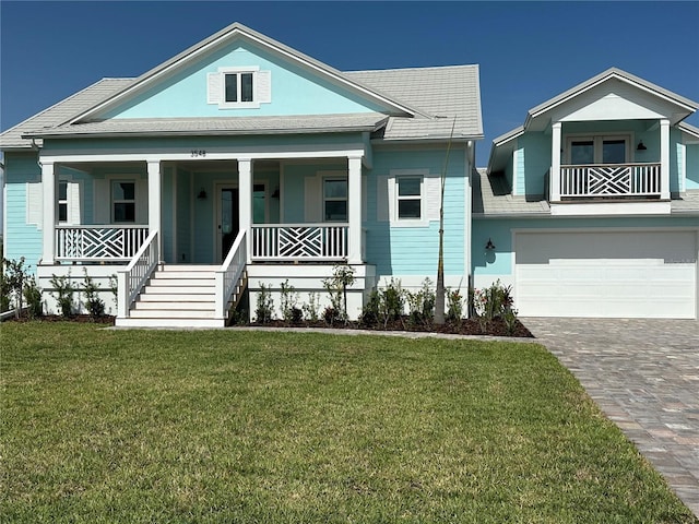 3548 Mondovi Ct, Punta Gorda, FL 33950 - view of front of house featuring a garage, covered porch, a front lawn, and driveway