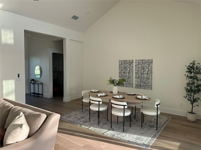 3548 Mondovi Ct, Punta Gorda, FL 33950 - dining area with wood finished floors, high vaulted ceiling, and baseboards