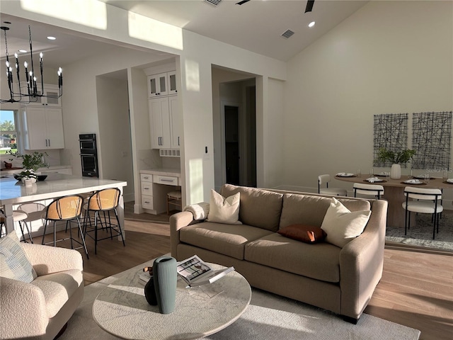 3548 Mondovi Ct, Punta Gorda, FL 33950 - living room with light wood finished floors, a chandelier, high vaulted ceiling, and recessed lighting