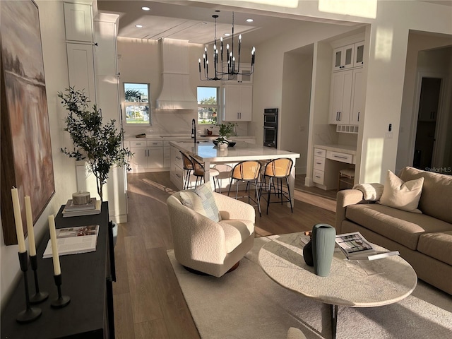 3548 Mondovi Ct, Punta Gorda, FL 33950 - living area featuring wood finished floors, a chandelier, and recessed lighting