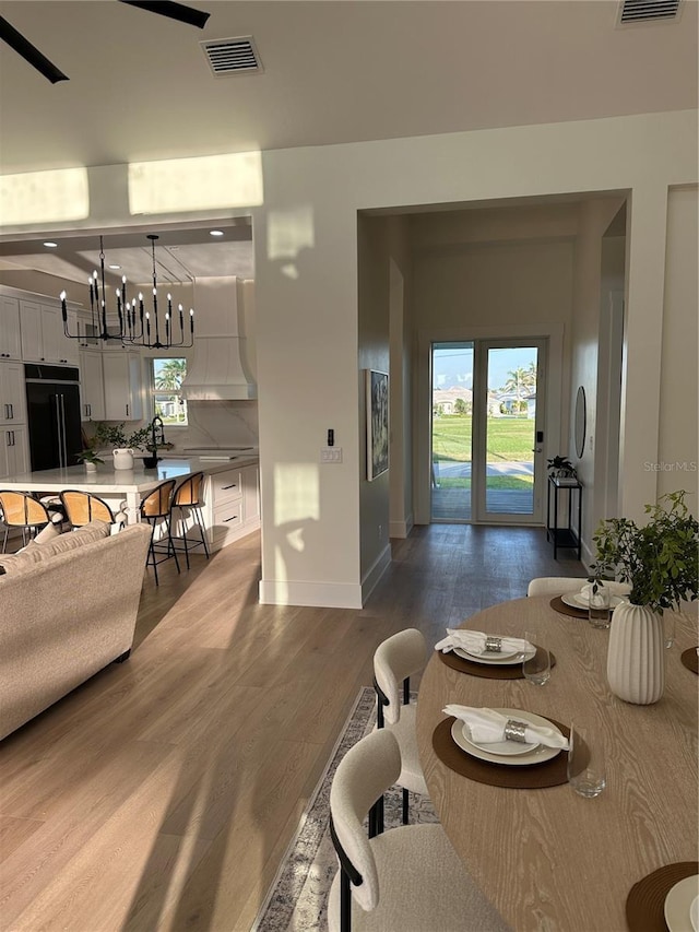 3548 Mondovi Ct, Punta Gorda, FL 33950 - dining space with wood finished floors, baseboards, and a chandelier