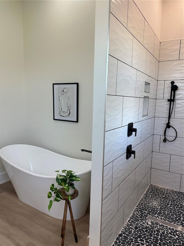 3548 Mondovi Ct, Punta Gorda, FL 33950 - bathroom with a freestanding tub, wood finished floors, and tiled shower