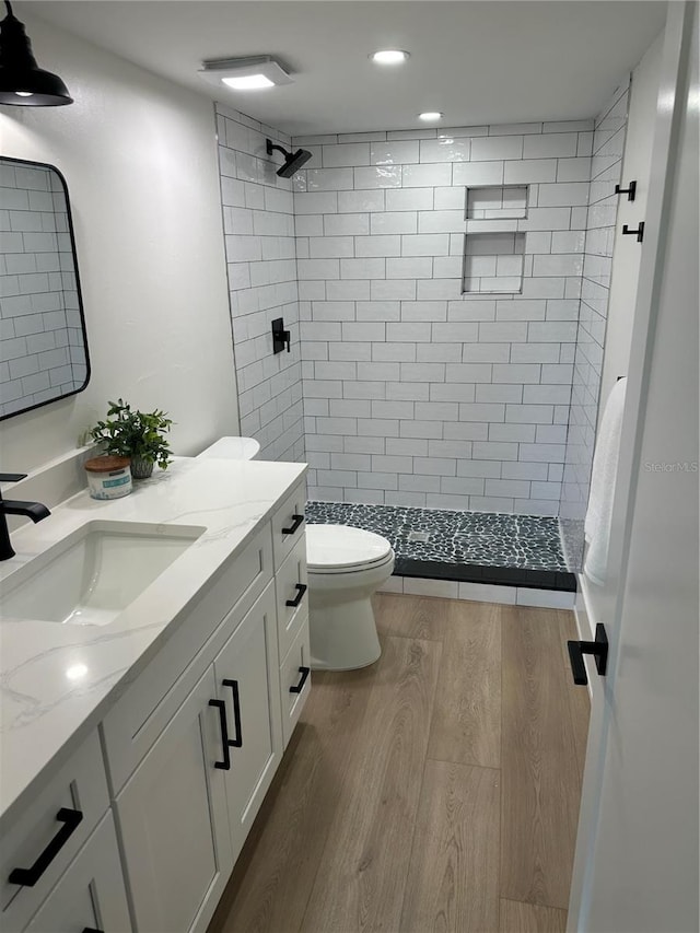 3548 Mondovi Ct, Punta Gorda, FL 33950 - full bath featuring vanity, toilet, a stall shower, wood finished floors, and recessed lighting