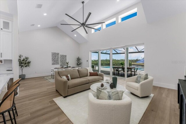 3548 Mondovi Ct, Punta Gorda, FL 33950 - living area with a ceiling fan, high vaulted ceiling, light wood-style floors, and recessed lighting