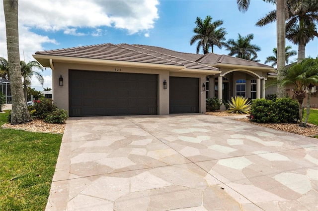 523 Saint Girons Ct, Punta Gorda, FL 33950 - view of front of house featuring an attached garage, stucco siding, concrete driveway, and a tile roof