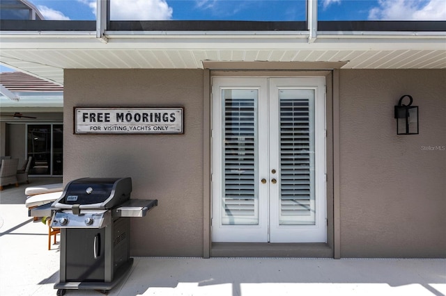 523 Saint Girons Ct, Punta Gorda, FL 33950 - view of exterior entry featuring french doors and stucco siding