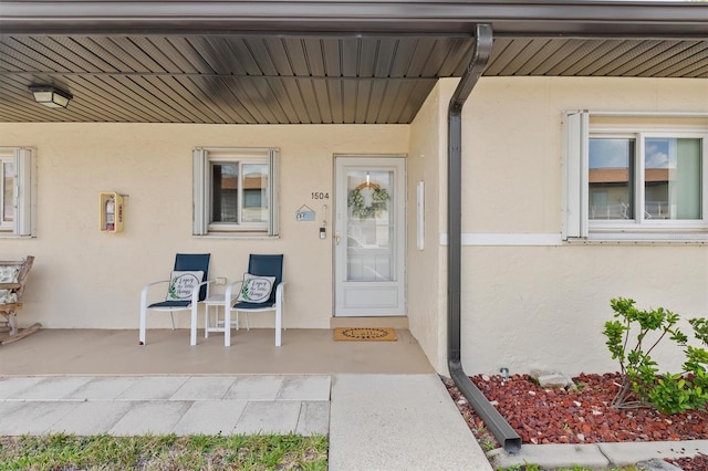 25275 Rampart Blvd Unit 1504, Punta Gorda, FL 33983 - doorway to property with stucco siding and a porch