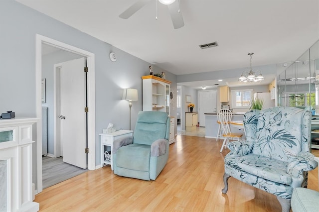 25275 Rampart Blvd Unit 1504, Punta Gorda, FL 33983 - sitting room featuring light wood finished floors, ceiling fan, a chandelier, and baseboards