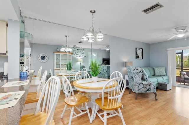 25275 Rampart Blvd Unit 1504, Punta Gorda, FL 33983 - dining area with a ceiling fan, light wood-style flooring, and a chandelier