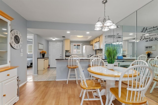 25275 Rampart Blvd Unit 1504, Punta Gorda, FL 33983 - dining space featuring light wood-style flooring, a chandelier, and baseboards