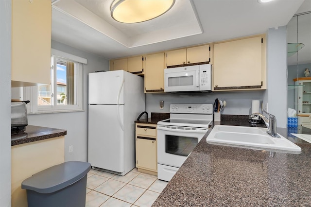 25275 Rampart Blvd Unit 1504, Punta Gorda, FL 33983 - kitchen featuring white appliances, cream cabinetry, a sink, dark countertops, and a tray ceiling