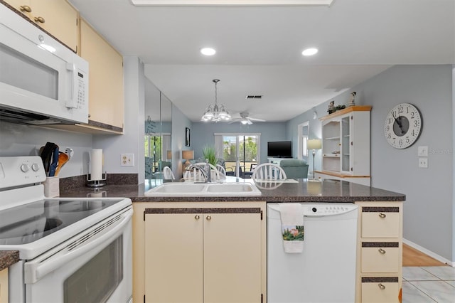 25275 Rampart Blvd Unit 1504, Punta Gorda, FL 33983 - kitchen featuring white appliances, a sink, a peninsula, open floor plan, and cream cabinetry