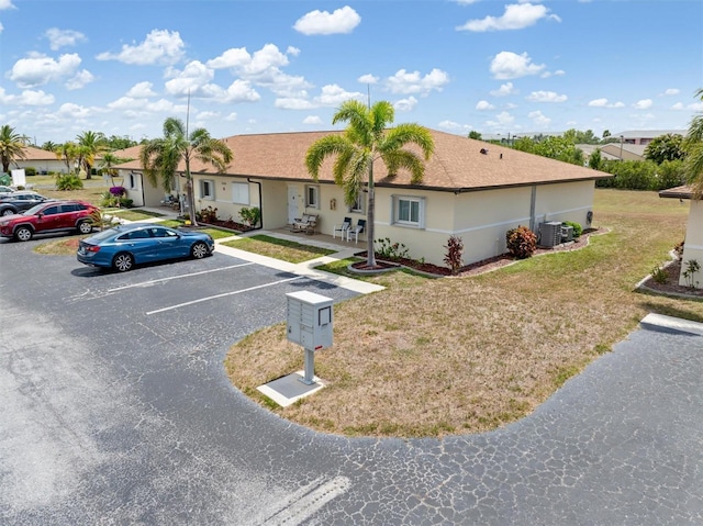 25275 Rampart Blvd Unit 1504, Punta Gorda, FL 33983 - ranch-style home featuring uncovered parking, a front yard, central AC, and stucco siding