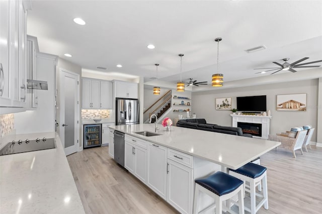 19821 Montenero Way, Venice, FL 34293 - kitchen featuring a ceiling fan, a sink, stainless steel appliances, wine cooler, and open floor plan