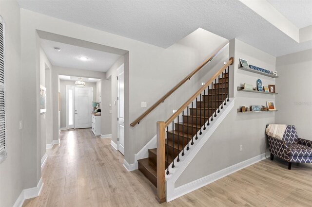 19821 Montenero Way, Venice, FL 34293 - foyer with light wood-style floors, stairs, and baseboards