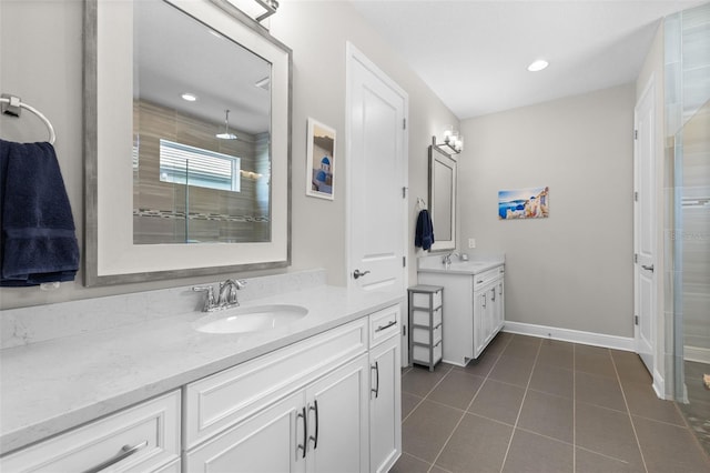 19821 Montenero Way, Venice, FL 34293 - full bathroom with two vanities, a shower stall, tile patterned floors, baseboards, and recessed lighting