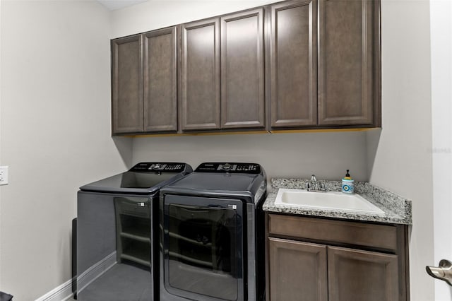 19821 Montenero Way, Venice, FL 34293 - washroom with washer and clothes dryer, cabinet space, and baseboards