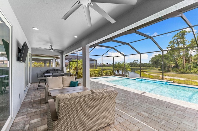 19821 Montenero Way, Venice, FL 34293 - swimming pool with a ceiling fan, a patio area, an outdoor living space, and glass enclosure