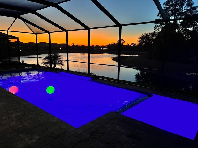 19821 Montenero Way, Venice, FL 34293 - view of pool featuring glass enclosure, a water view, and a patio