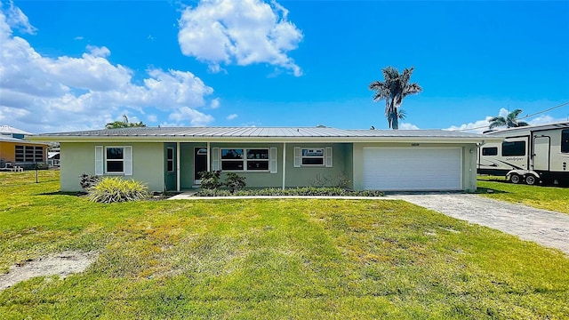 24239 Yacht Club Blvd, Punta Gorda, FL 33955 - single story home with stucco siding, an attached garage, driveway, and a front lawn