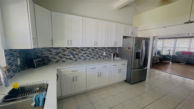 24239 Yacht Club Blvd, Punta Gorda, FL 33955 - kitchen with stainless steel fridge, light countertops, white cabinets, and light tile patterned floors