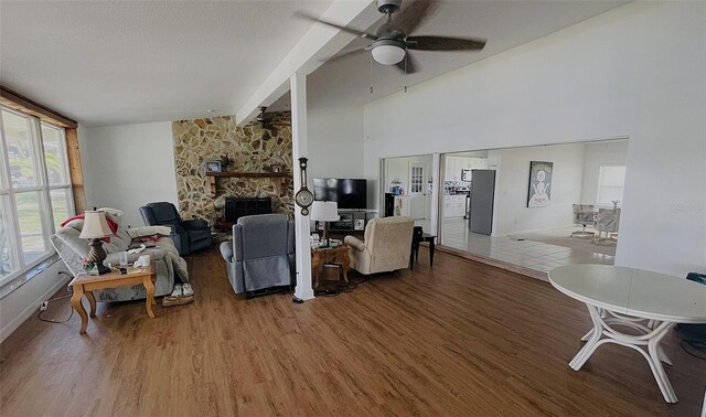 24239 Yacht Club Blvd, Punta Gorda, FL 33955 - living room with wood finished floors, a ceiling fan, and a stone fireplace
