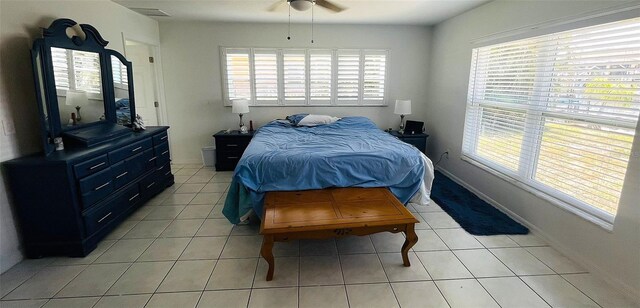 24239 Yacht Club Blvd, Punta Gorda, FL 33955 - bedroom featuring multiple windows, light tile patterned floors, and a ceiling fan