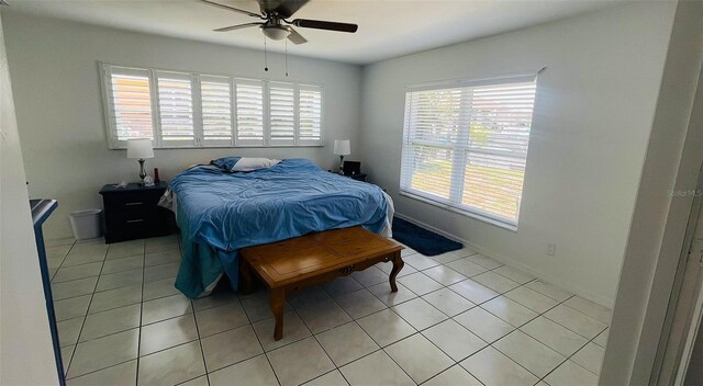 24239 Yacht Club Blvd, Punta Gorda, FL 33955 - bedroom featuring multiple windows, light tile patterned floors, and a ceiling fan