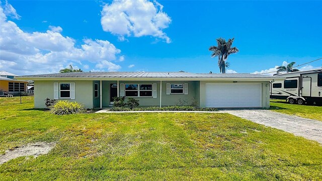24239 Yacht Club Blvd, Punta Gorda, FL 33955 - single story home featuring stucco siding, an attached garage, driveway, and a front yard