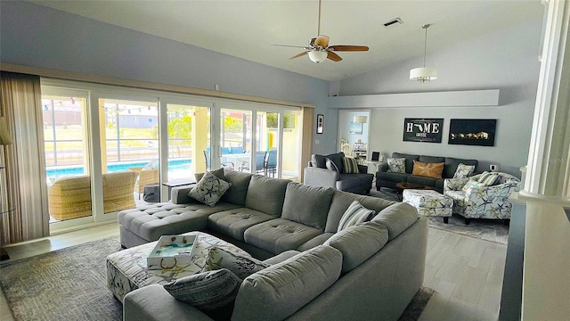 2399 Bendway Dr, Port Charlotte, FL 33948 - living area with a ceiling fan, vaulted ceiling, and light wood finished floors